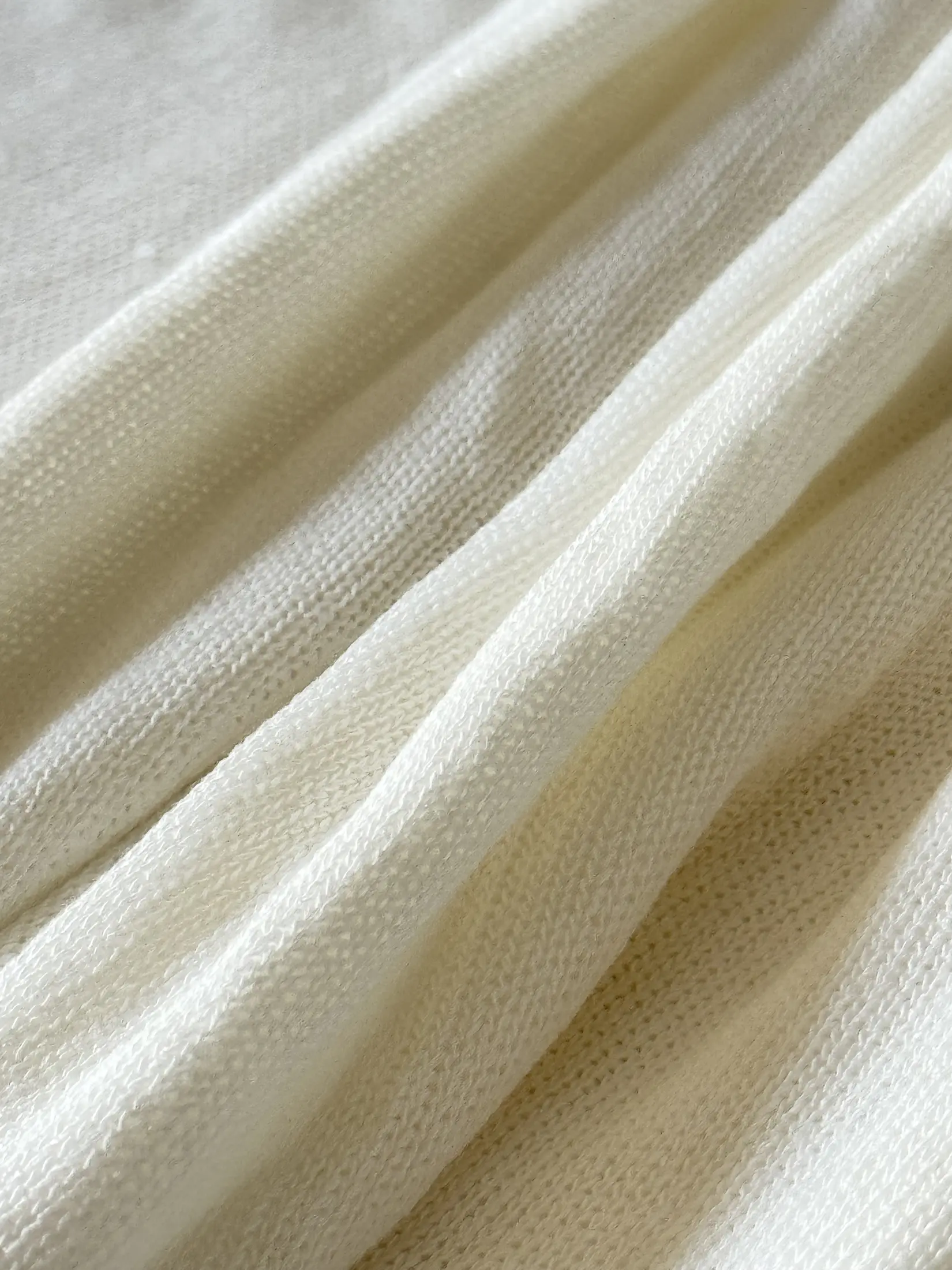 Cream FlexaKnit fabric falling in soft folds
