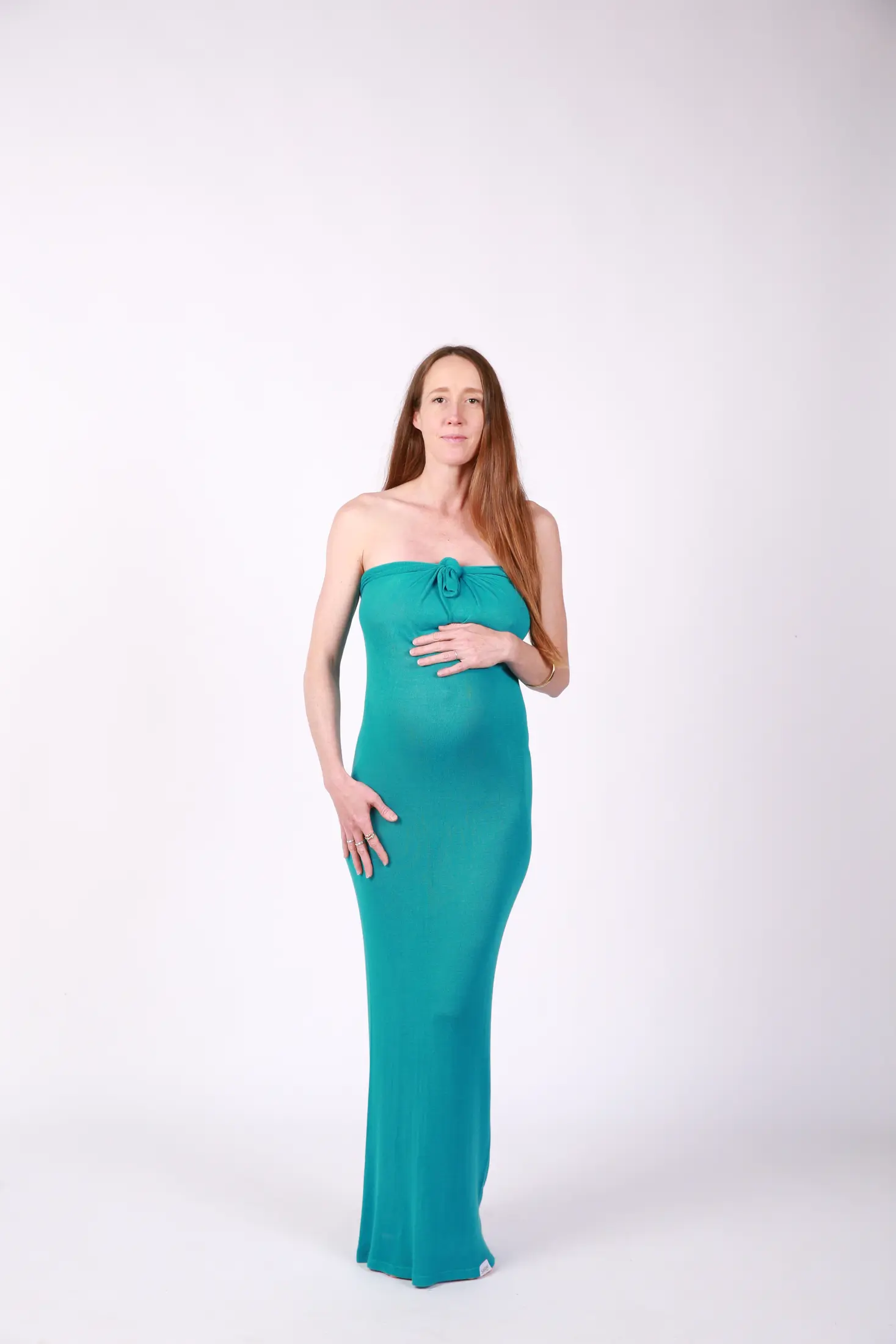 Teal FlexaKnit following the curve of a pregnant belly